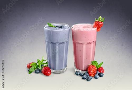 Tasty milkshake with blueberries in a glass on  background. Healthy dessert