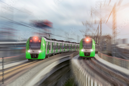 Two city passenger railway trains cross the bridge and turn at high speed.