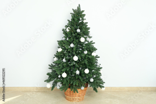 Composition with Christmas tree on background floor photo