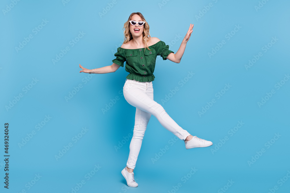 Photo of funny funky lady dance wear bear shoulders green blouse pants footwear isolated blue color background