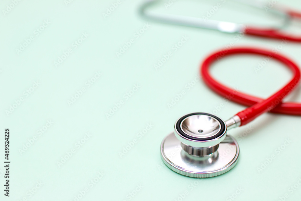 Close up of the medical object. stethoscope on green background. selective focus Close up of the medical object. stethoscope on green background. selective focus
