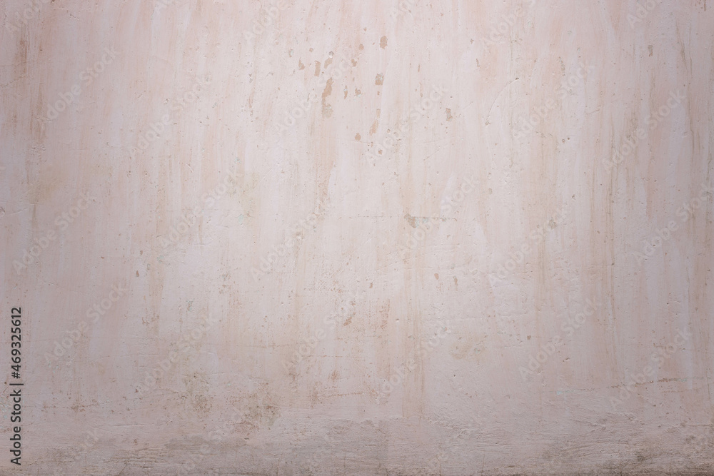 Beige concrete wall texture. Wonderful light-yellow backdrop with streaks and vignette. Beige concrete wall texture. Wonderful light-yellow backdrop with streaks and vignette.