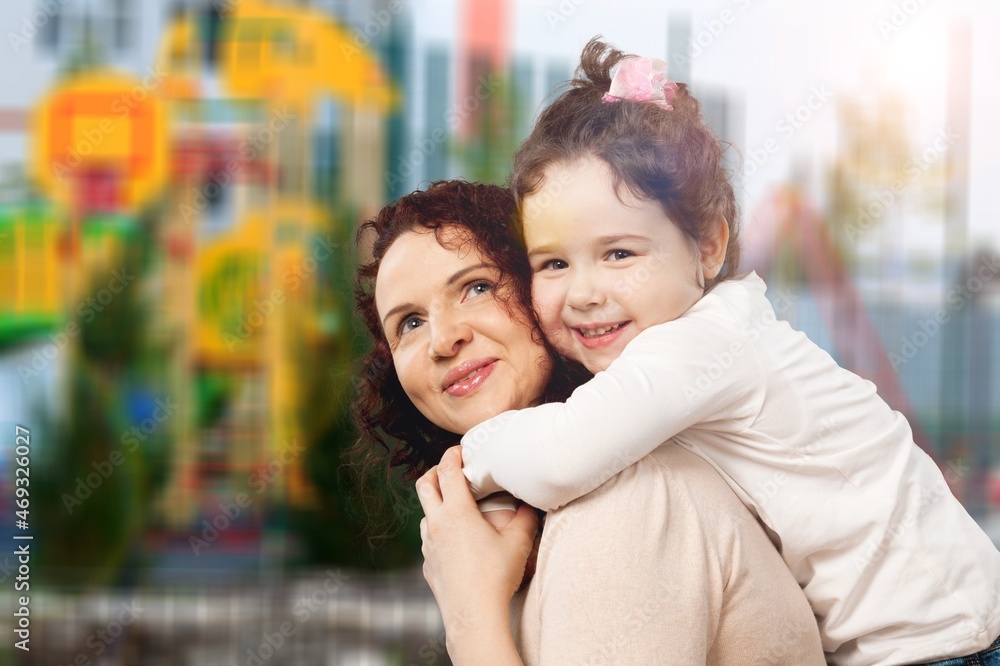 Young happy woman piggybacking a little girl. Young happy woman piggybacking a little girl.
