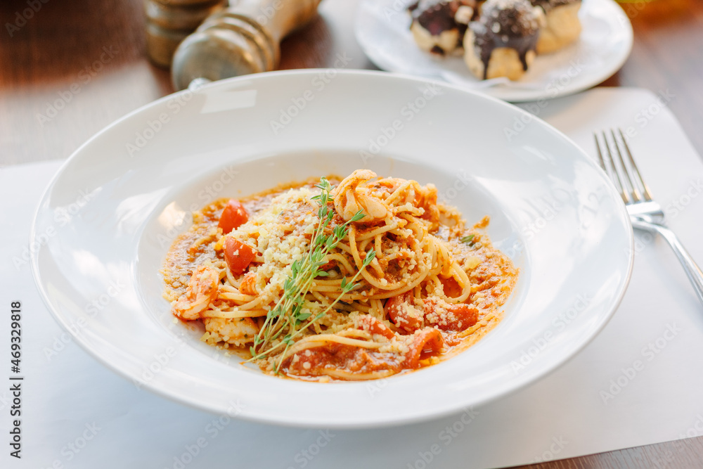 Spaghetti pasta with tomatoes and shrimps in a restaurant of italian food Spaghetti pasta with tomatoes and shrimps in a restaurant of italian food