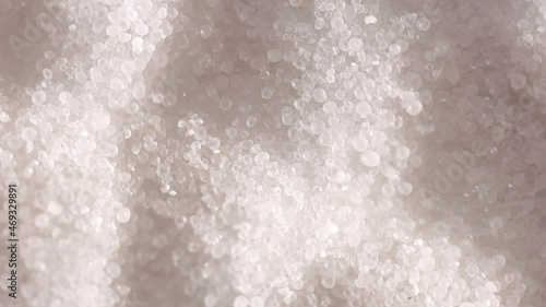 Sugar or Salt taken with Spoon from a bowl at closeup. Slow motion.