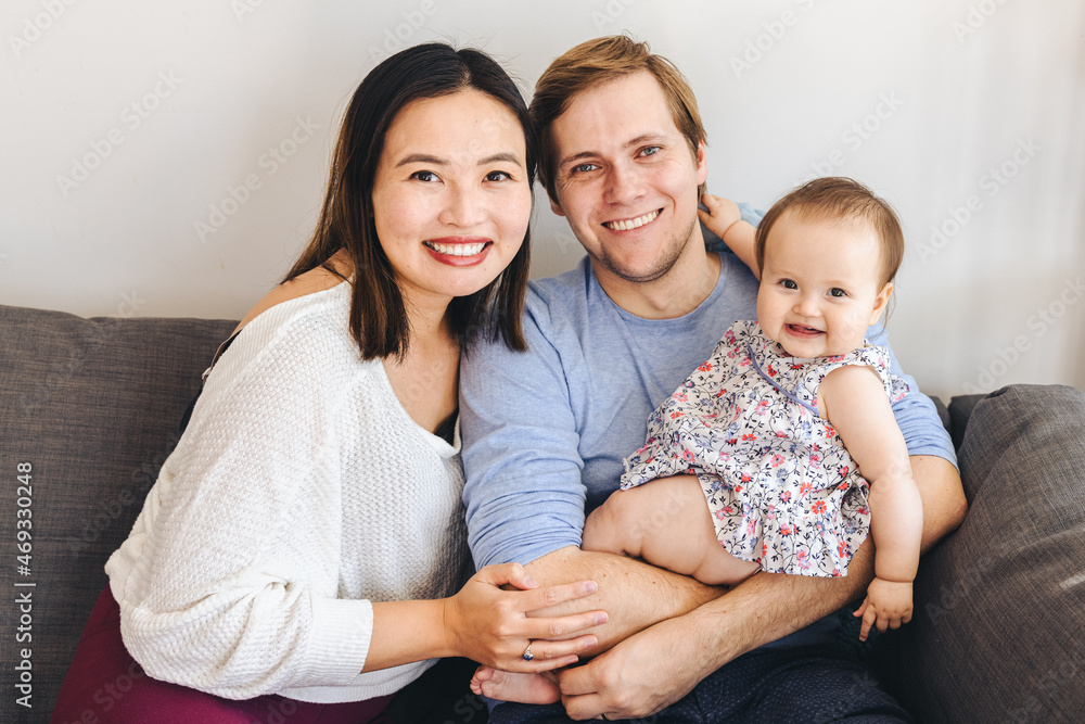 Happy Multi Ethnic Parents With Adorable Daughter