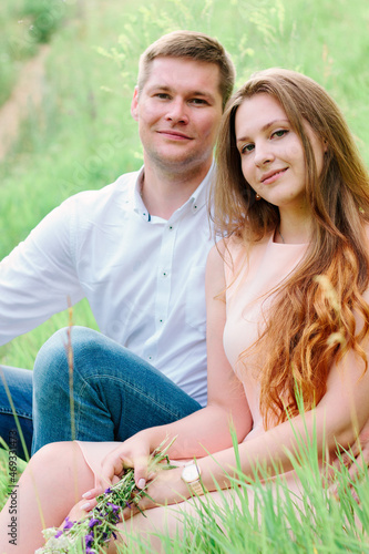Young lovely couple sitting...