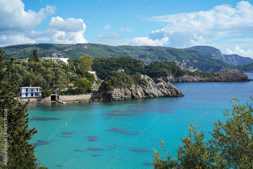turquoise sea and cliff coastline of touristic town Paleokastritsa, Corfu island, Greece