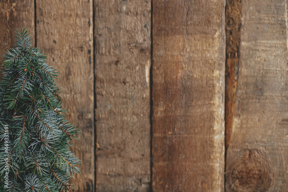 Stylish christmas tree on rustic background. Space for text. Season's greeting. Handmade fir tree Stylish christmas tree on rustic background. Space for text. Season's greeting. Handmade fir tree