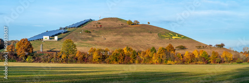 A mountain with a solar cell power plant in the warm morning lights, Solarberg, Fürth, Bavaria, Germany