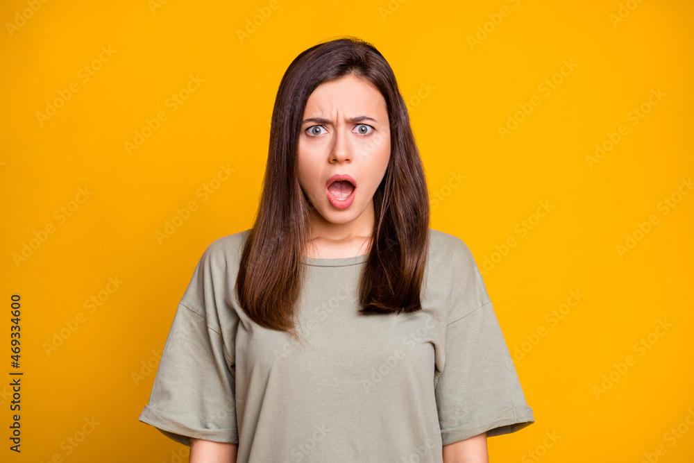 Photo of young shocked amazed surprised scared terrified girl with open mouth hear bad news isolated on yellow color background Photo of young shocked amazed surprised scared terrified girl with open mouth hear bad news isolated on yellow color background