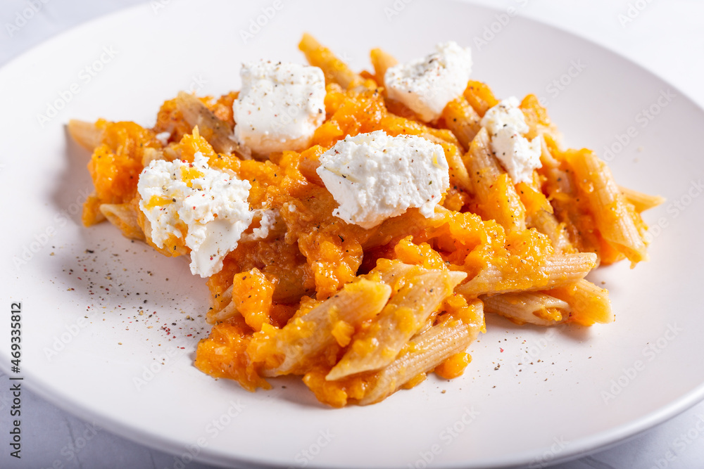 Pasta with pumpkin and goat cheese. Autumnal pasta with pumpkin.