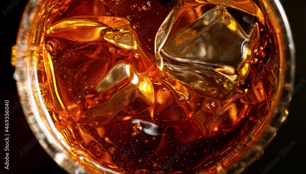 Top shot of whisky glass with ice cubes, closeup. Top shot of whisky glass with ice cubes, closeup.