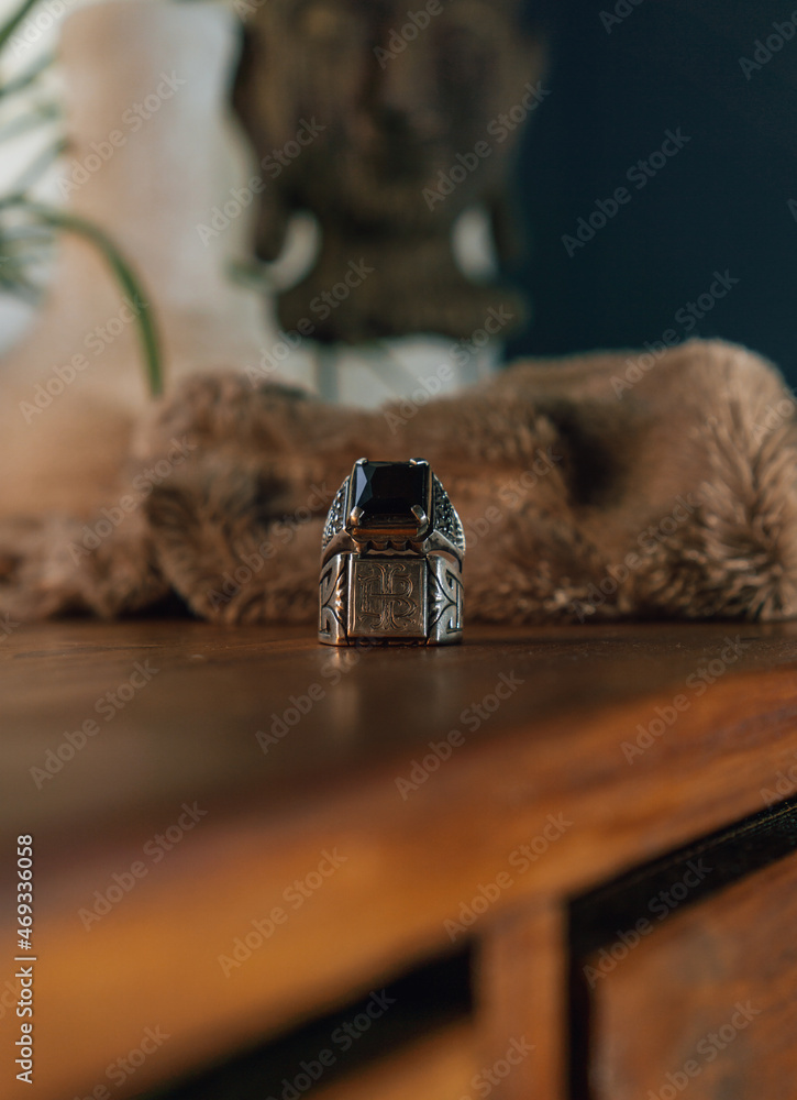 two gold and silver rings on a wooden table