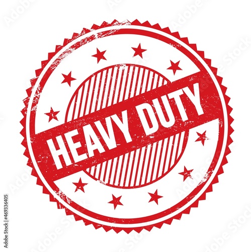 Φωτογραφία HEAVY DUTY text written on red grungy round stamp.