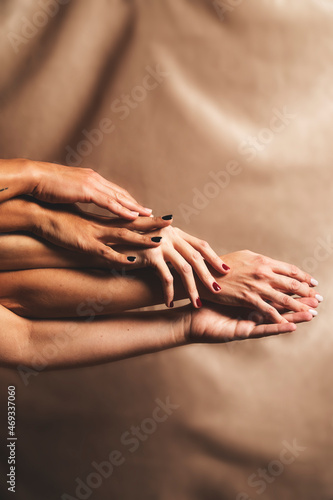 Five woman's hands with different manicures take care of each other and caress each other. Union, diversity, community, sisterhood. photo