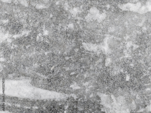 Closeup photo of slick frozen winter road after snow