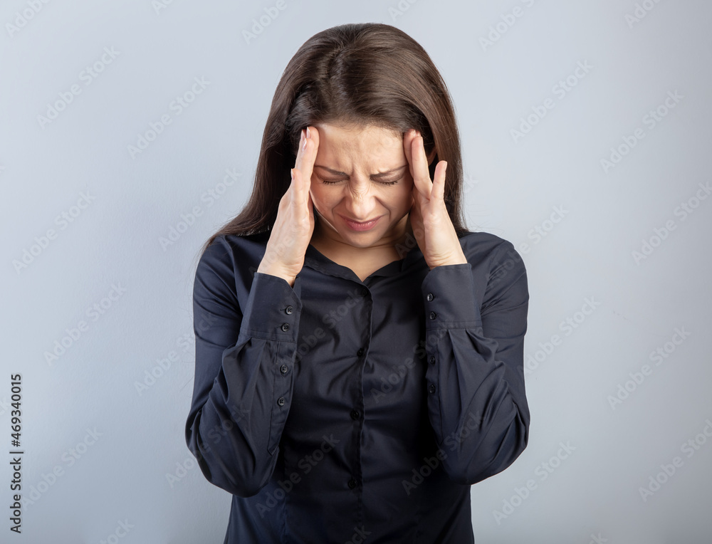 Beautiful serious unhappy concentrated thinking young woman with closed eyes solving the problem on empty blue studio copy space. Closeup Beautiful serious unhappy concentrated thinking young woman with closed eyes solving the problem on empty blue studio copy space. Closeup