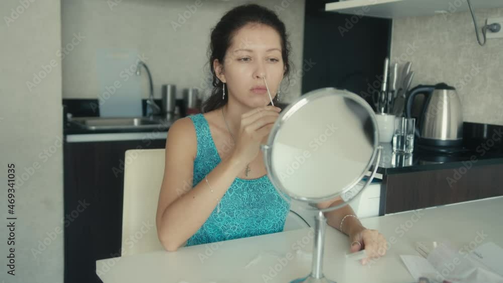Young woman performs a Covid-19 antigen self-test Young woman performs a Covid-19 antigen self-test