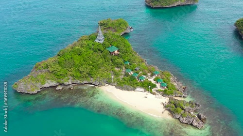 Beautiful beach on a tropical island with tourists, aerial view. Lopez Island, Hundred Islands National Park, Pangasinan, Philippines. Alaminos. Summer and travel vacation concept photo