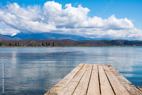 wooden pier on the lake from old boards