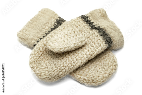 Knitted warm woolen mittens on a white background