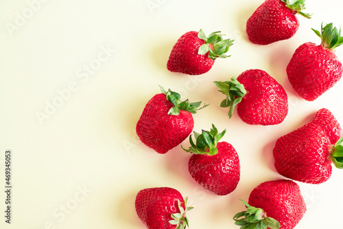Strawberry isolated. Strawberry with leaf. A whole strawberry on a yellow background. Delicious background with strawberries.