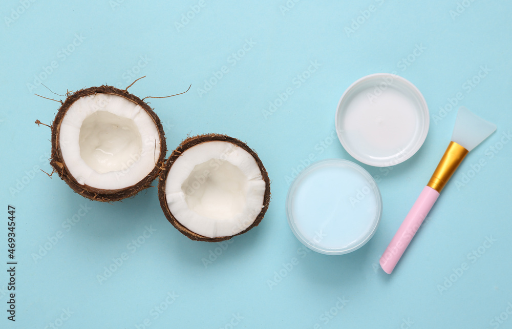 Jar of face cream with coconut on a blue background. Top view