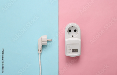 Fuse power outlet and power plug on blue pink pastel background