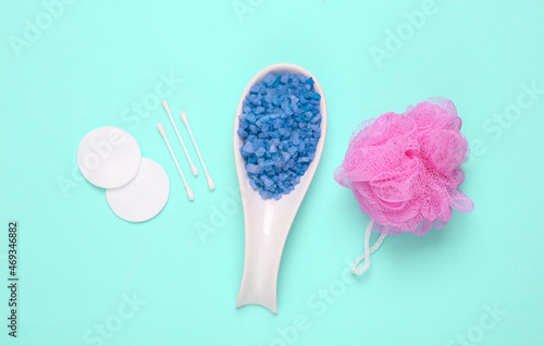 Bath salt, washcloth, cotton pads and sticks on blue background. Top view