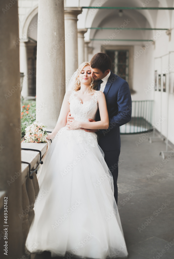 Naklejka premium Gorgeous wedding couple walking in the old city of Lviv