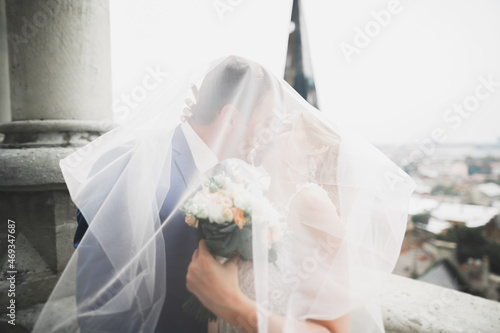Gorgeous wedding couple walking in the old city of Lviv