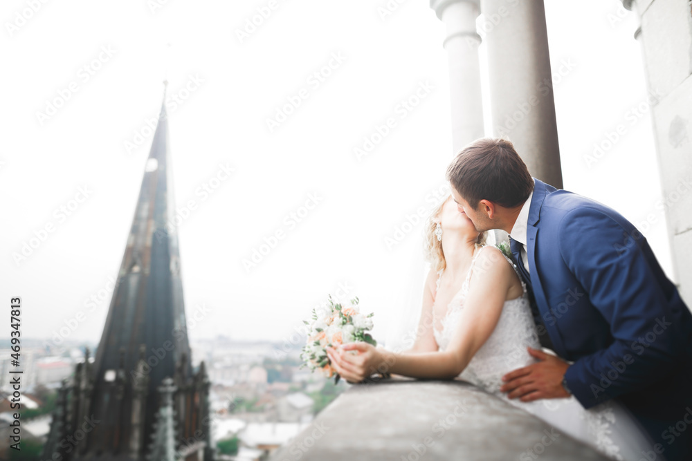 Gorgeous wedding couple walking in the old city of Lviv