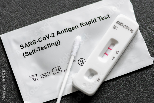 Positive Covid-19 antigen test kit for self testing, one step coronavirus antigen rapid test, saliva swab, 1 test box, close up photo