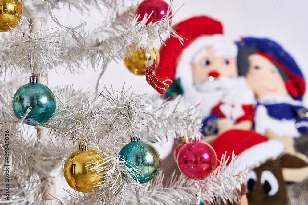 Christmas season, Christmas parties ,. Christmas tree with colored spheres and white luminous background. Christmas season, Christmas parties ,. Christmas tree with colored spheres and white luminous background.
