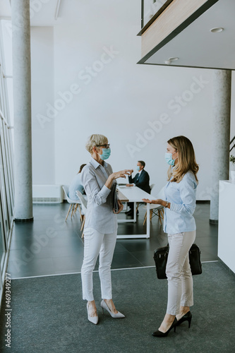 Two businesswomen talking i...