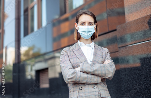 Portrait of a business business woman with a medical mask in the city