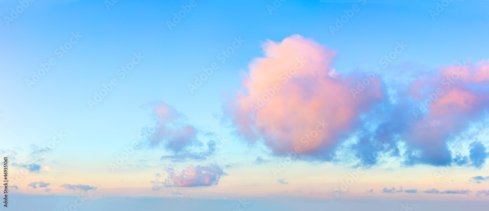 Light pink clouds in the blue sky during dawn sunset, real pastel colors. Panoramic background