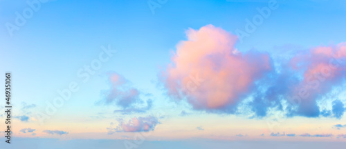 Canvas Print Light pink clouds in the blue sky during dawn sunset, real pastel colors
