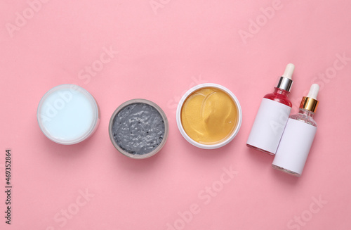 Set for facial care on a pink background. Flat lay beauty composition. Skin care, lifting face concept. Top view