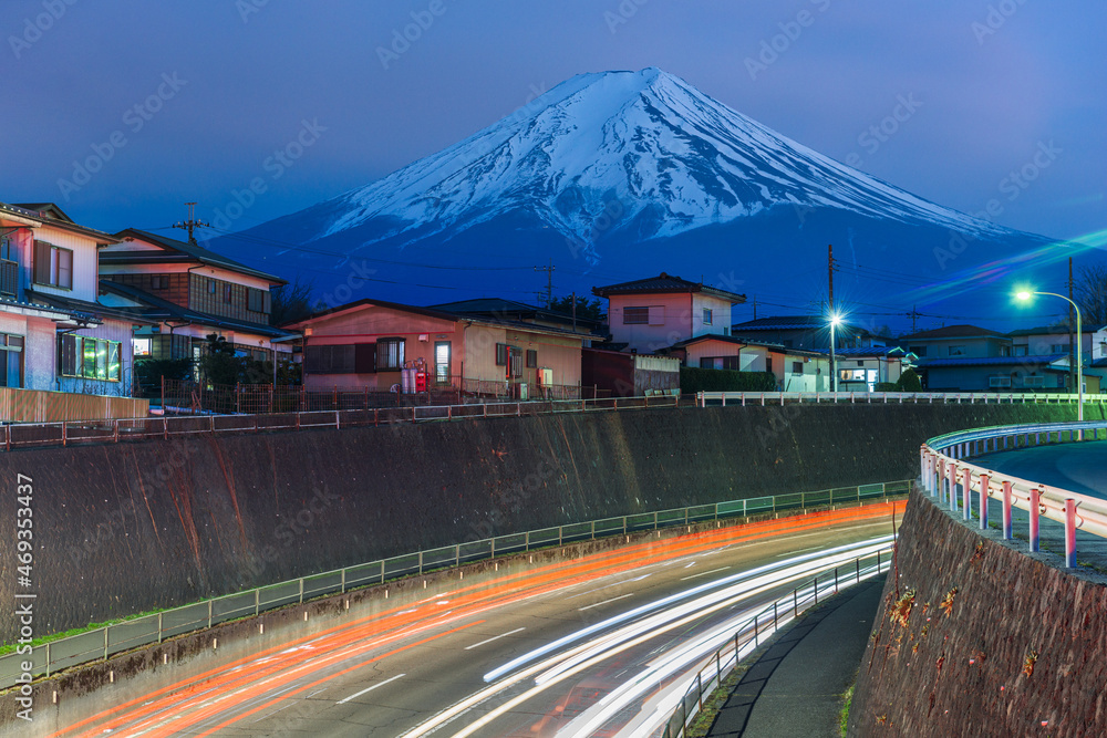 Mt. Fuji, Japan over neighborhoods and highways.