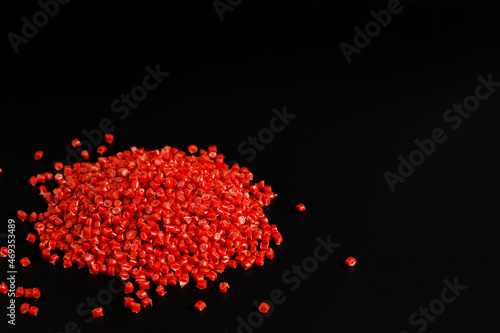 Many red granules of polypropylene, polyamide. Background. Plastic and polymer industry, industry. Microplastic products.