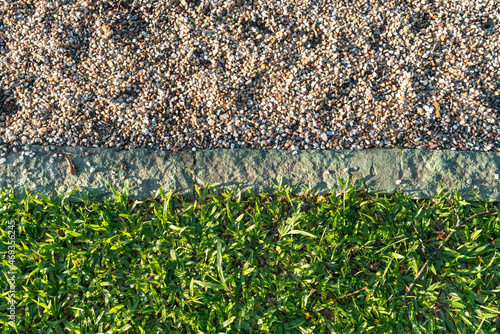 a grama do campo separada das pedras pela linha branca que marca o gramado do futebol photo