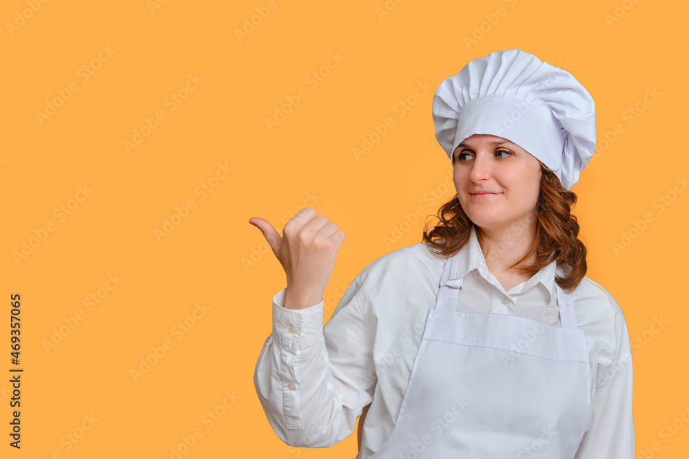 Woman chef on yellow studio background shows with hand on copy space for text Woman chef on yellow studio background shows with hand on copy space for text