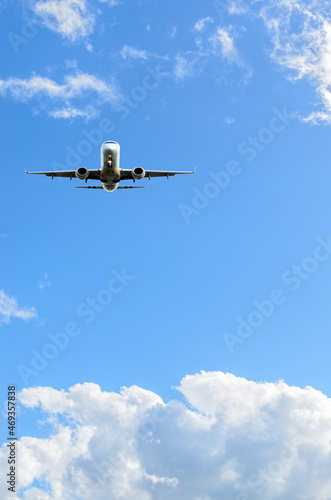 flight of the airplane (jet) over beautiful blue sky with white clouds
