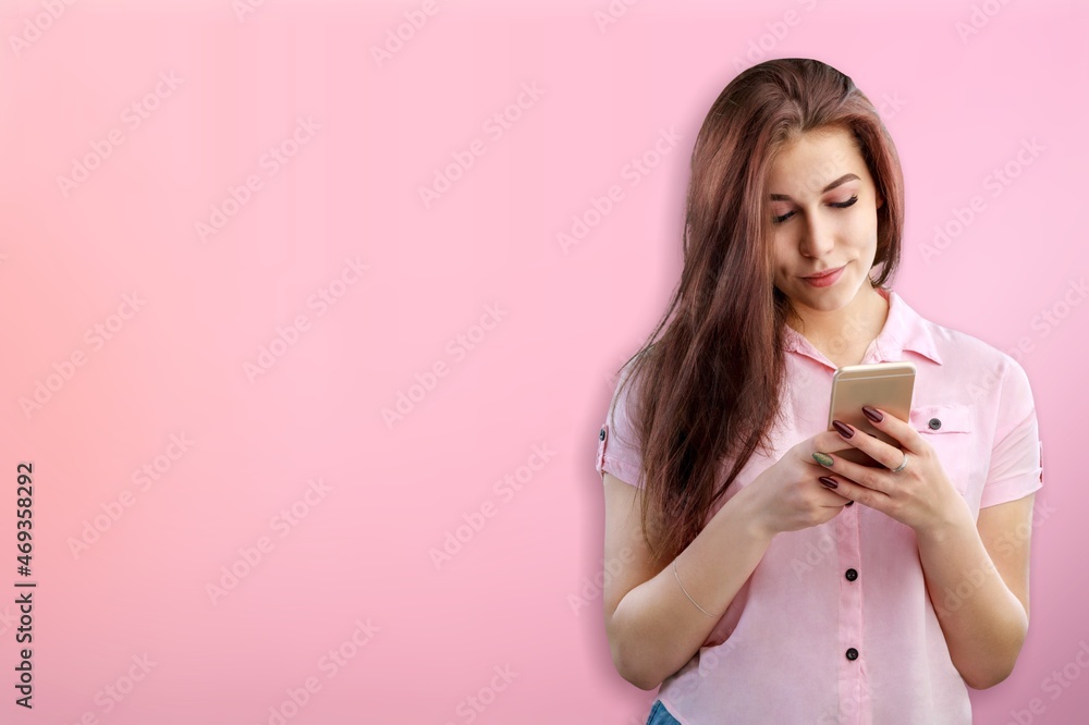 Happy beautiful cute young woman teen smiling excited typing text message on smart mobile Happy beautiful cute young woman teen smiling excited typing text message on smart mobile