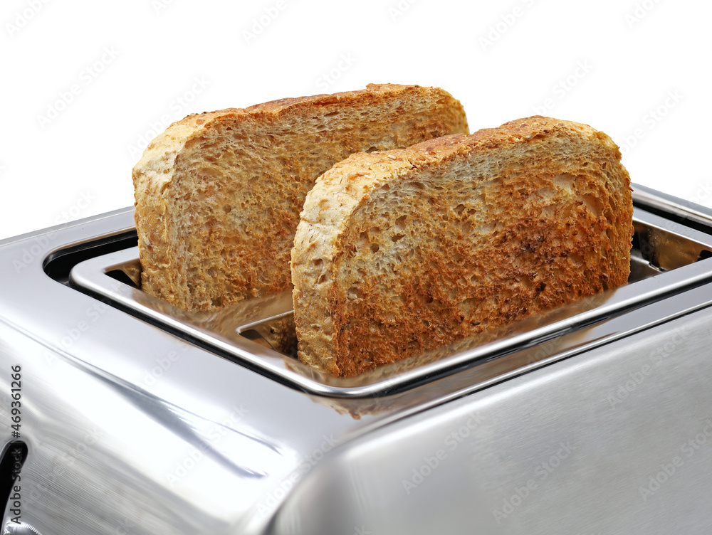 two slices of toasted wholemeal bread in silver toaster isolated on white background two slices of toasted wholemeal bread in silver toaster isolated on white background