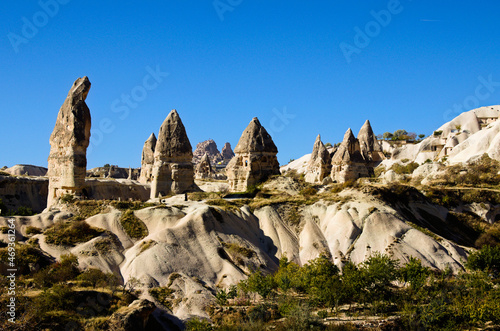 Amazing landscape view of ancient cave houses in Goreme at sunny autumn morning. Underground city inside the rocks. Fabulous landscapes of the mountains and spectacular rocks formations of Cappadocia