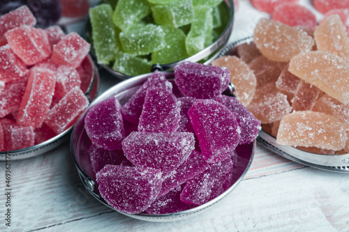 Dessert marmalade in the form of lemon and orange slices. The sweetness of jelly candy. photo