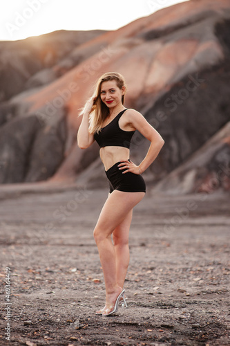 Beautiful girl fitness model in the mountains